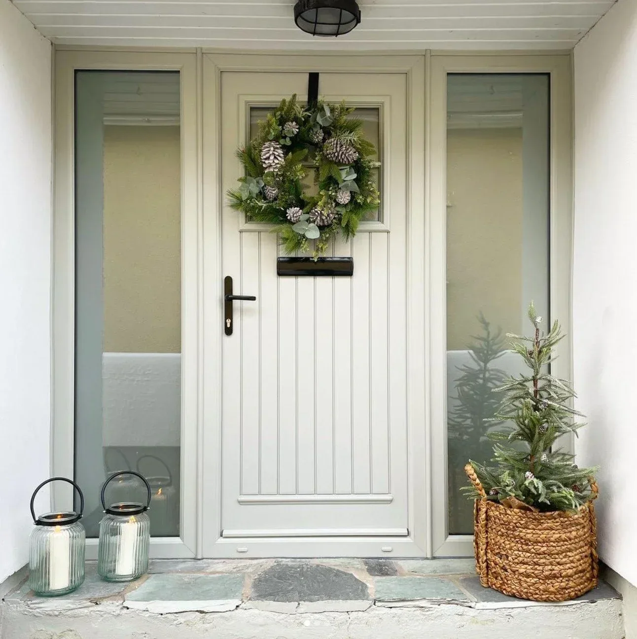 Light grey composite front door with full-height glazed side panels and a festive wreath