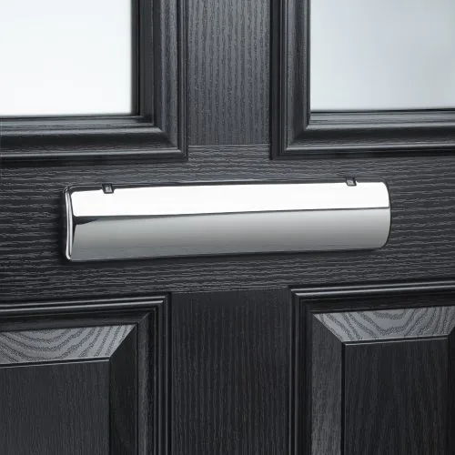 Polished chrome letterplate on a black panelled composite front door