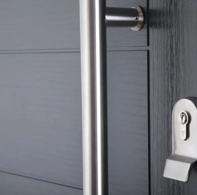 Close-up of a dark grey composite front door with a stainless steel bar handle, a lever handle and a euro cylinder lock