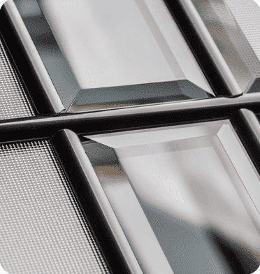 Close-up of bevelled composite door glass with clear and textured panes in black frames
