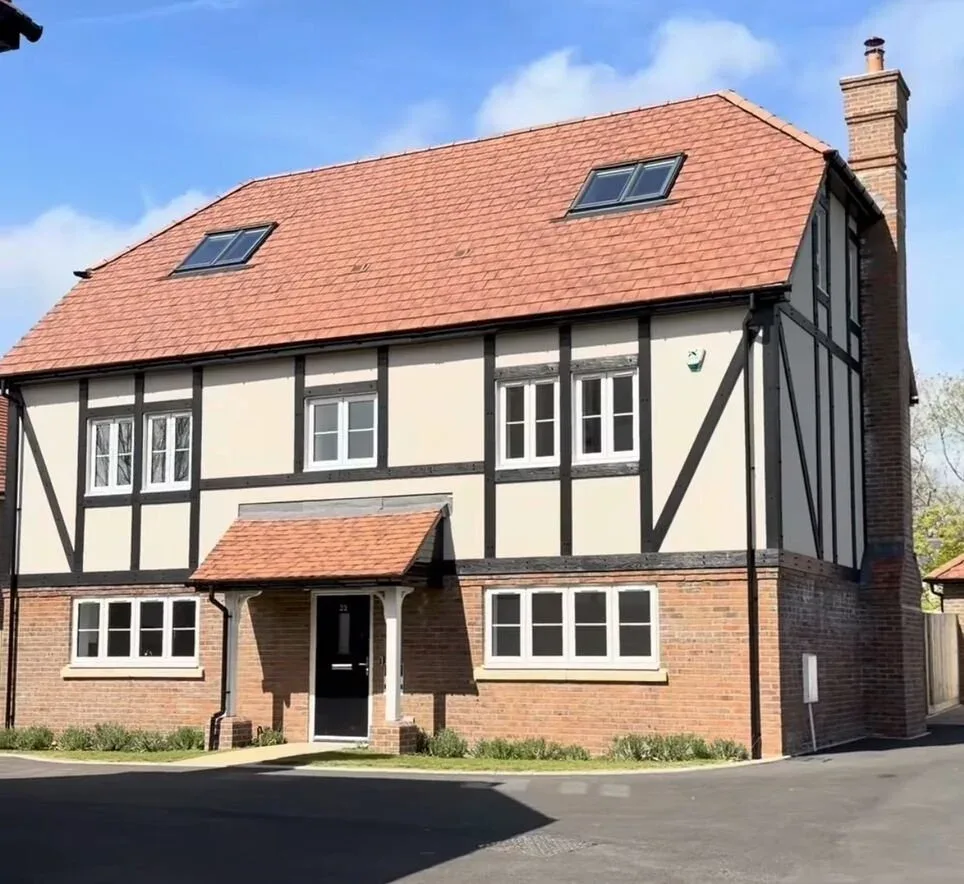 Riverdale Developments new-build house with white windows, a black front door and a red tiled roof