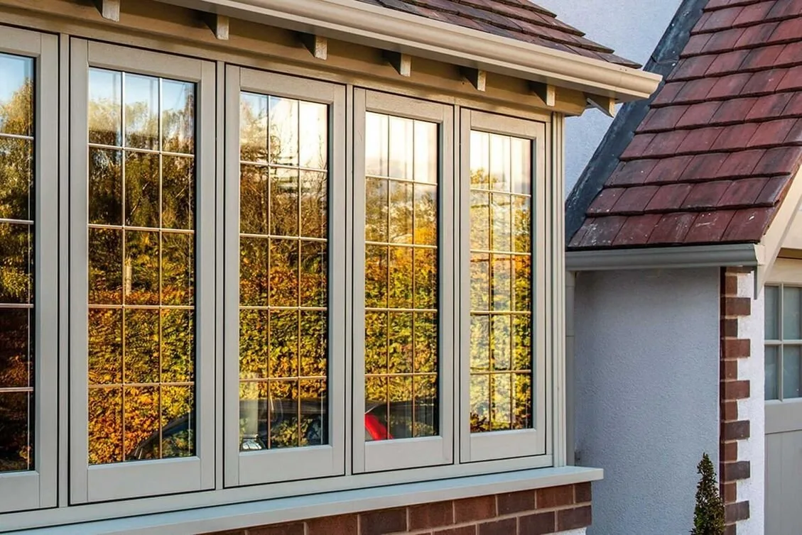 Grey timber-look bay window with Georgian bars under a red tiled roof